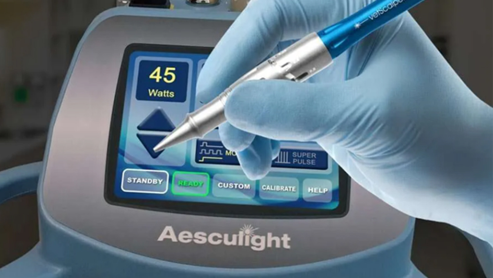 Veterinarian performing laser surgery on a pet at Boca Midtowne Animal Hospital